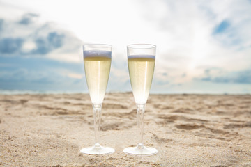 Champagne Flute Glasses On Sandy Beach