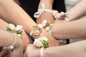 Corsages on the Wrists of Bridesmaids hands