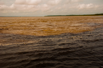 Manaus, Amazonas, Brazil: The merger of the two colored river, Rio Negro, Solimoes.
