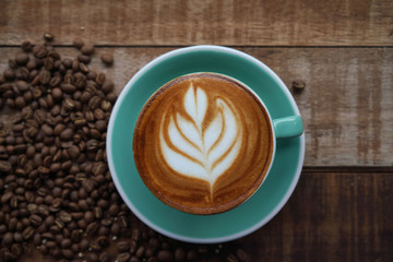 hot Coffee in coffee cup on wooden table in cafe