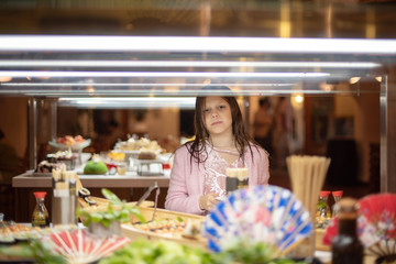 girl chooses sushi on the buffet