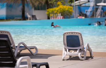 Beach chair or sundeck at swimming pool in waterpark