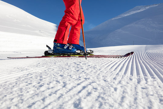 Low section of male skier with skis on a ski slope