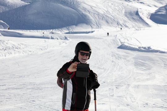 Older man taking selfie on the ski slope