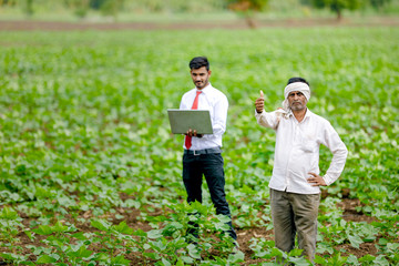 agronomist with farmer at cotton field