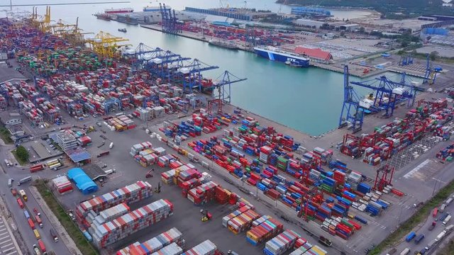 Aerial top view of container cargo ship in the export and import business and logistics international goods in urban city. Shipping to the harbor by crane in Laem Chabang, Chon Buri, Thailand