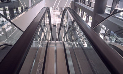 Fototapeta na wymiar Moving escalator in interior of office building