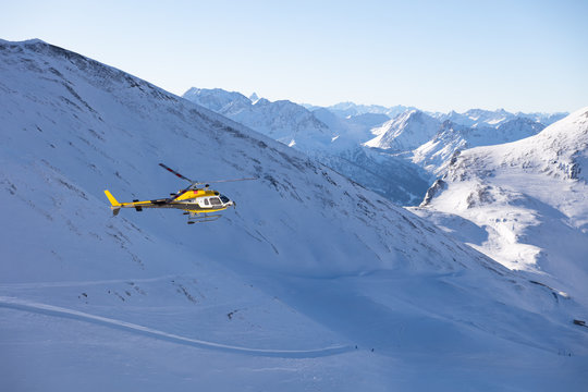 Helicopter flying above scenery with majestic mountains