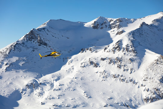 Rescue helicopter flying towards the mountains