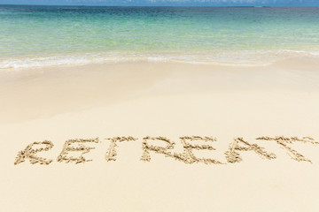 Retreat Text On Sand Near The Idyllic Sea At Beach