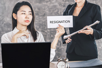 unhappy Asian female worker giving resignation latter to annoying boss quitting a job 