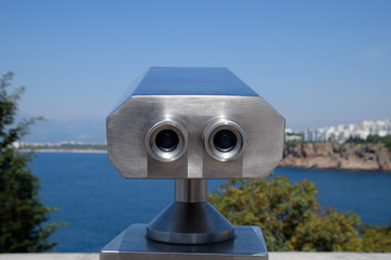 Inspection binoculars on the waterfront. Inspection of the Antalya embankment through the viewing binoculars.