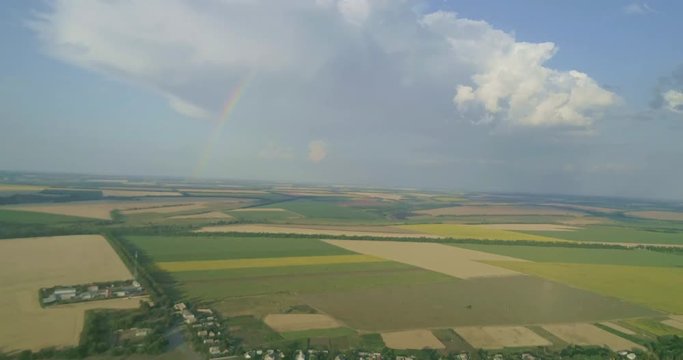 Rainbow over wheat, panic grass, maize, barley, oats, rhy fields