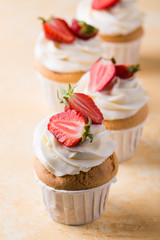 Strawberry cupcakes on yellow background