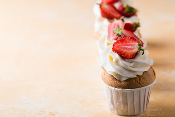 Strawberry cupcakes on yellow background