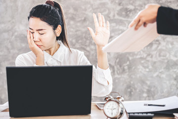tired and bored female Asian employee ignore annoying boss at office desk    - obrazy, fototapety, plakaty