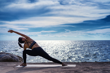 Fototapeta na wymiar Portrait of young woman practicing yoga at the sea.Relax at the sea.Meditation