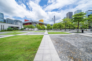Naklejka premium Shenzhen City, Guangdong Province, China, urban architecture and empty square grassland