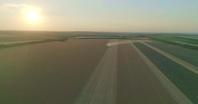 Farm machinery at the sunset is gathering in rhy