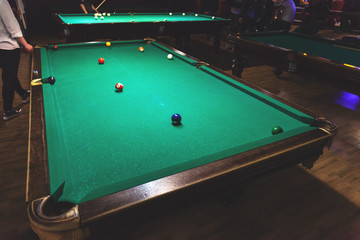 large vintage pool tables in the night bar, retro toned