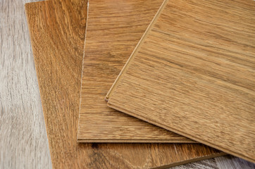 brown wooden parquet boards on a gray background. Close-up.