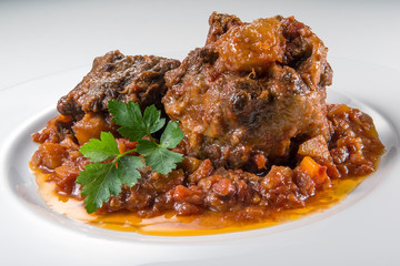 Dish with portion of oxtail stewed - obrazy, fototapety, plakaty