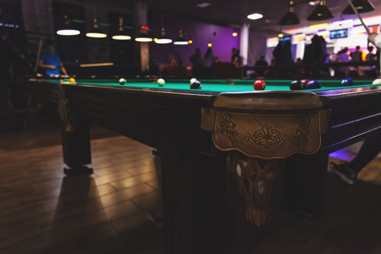 big old pool table with balls in the club, retro toned
