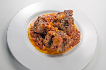 Isolated Dish with a portion of oxtail stewed vaccinara