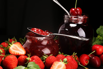 assortment of jams, seasonal berries, mint and fruits. marmalade or confiture
