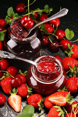 assortment of jams, seasonal berries, mint and fruits. marmalade or confiture