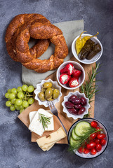 Traditional oriental snack or turkish breakfast with olives, simit bagels, feta cheese, stuffed grape leaves