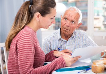 Obraz premium Portrait of mature father and daughter with documents