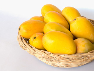ripe mango on basket white background