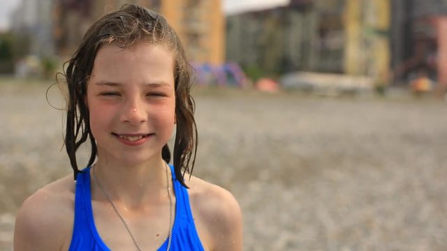 portrait of a teenage girl on the beach by the sea