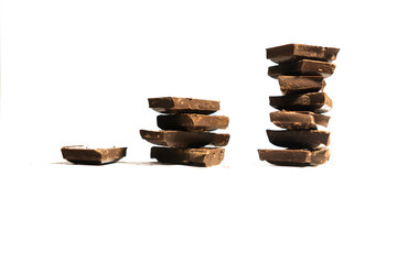 The concept of a profit graph made of chocolate cubes isolated on white background with copy space.