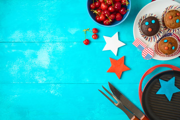 Happy Independence Day, 4th of July celebration concept with cupcakes and barbeque grill  on wooden background.