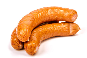 Meat sausages with glitter on a light background. Three boiled beef sausages. The concept of traditional cuisine.