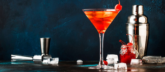 Classic alcoholic cocktail Manhattan with bourbon, red vemuth, bitter, ice and cocktail cherry in...