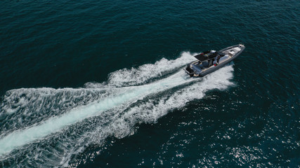 Aerial top view luxury inflatable rib speed boat cruising in Aegean deep blue open sea
