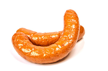 Boiled pork spicy sausages. Meat sausages with glitter on a light background. Junk food.