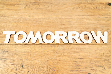 Word tomorrow on a wooden table