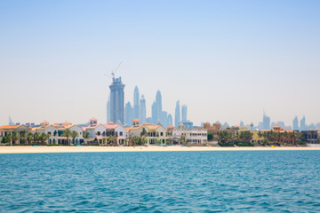 Fototapeta na wymiar Dubai Marina skyscrapers and villas on the Palm Jumeirah. Luxury properties of UAE