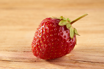 Strawberry separate closeup on a wooden base