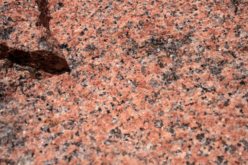 The texture of the red granite of different types. Background.