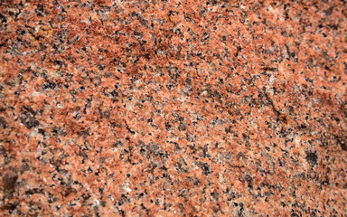 The texture of the red granite of different types. Background.