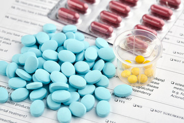Colorful pills on medical questionnaire form. 