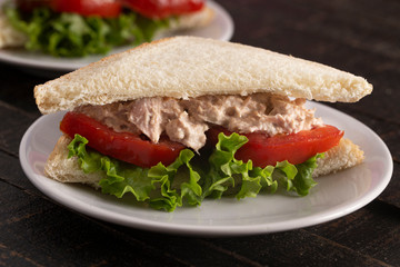 Tuna Salad Sandwich with Tomato and Lettuce on a Country Farm Table