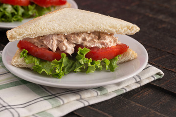 Tuna Salad Sandwich with Tomato and Lettuce on a Country Farm Table