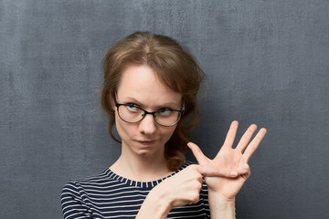 Portrait of girl counting of something with fingers