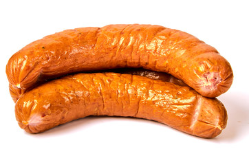 Two boiled sausages in a natural casing. Meat spicy juicy sausages with glitter on a light background.